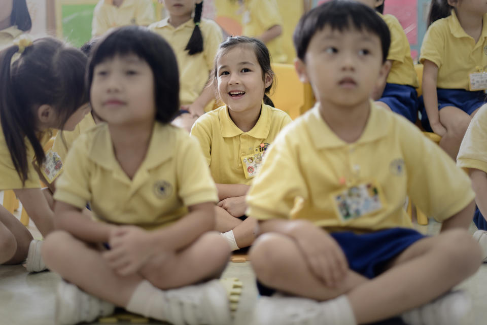 Maia (center) sits at her school in Hong Kong on June 17, 2013.  