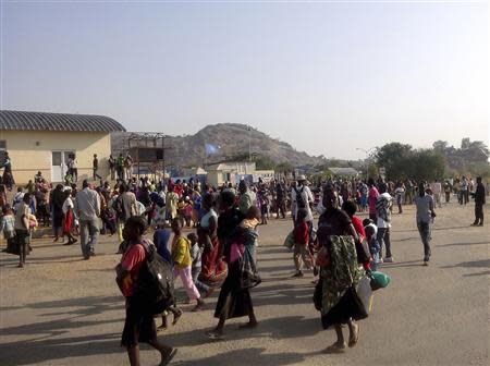 Civilians arrive outside the United Nations compound on the outskirts of capital Juba in South Sudan, in this December 16, 2013 handout from the United Nations Mission in South Sudan (UNMISS). REUTERS/UNMISS/Handout via Reuters