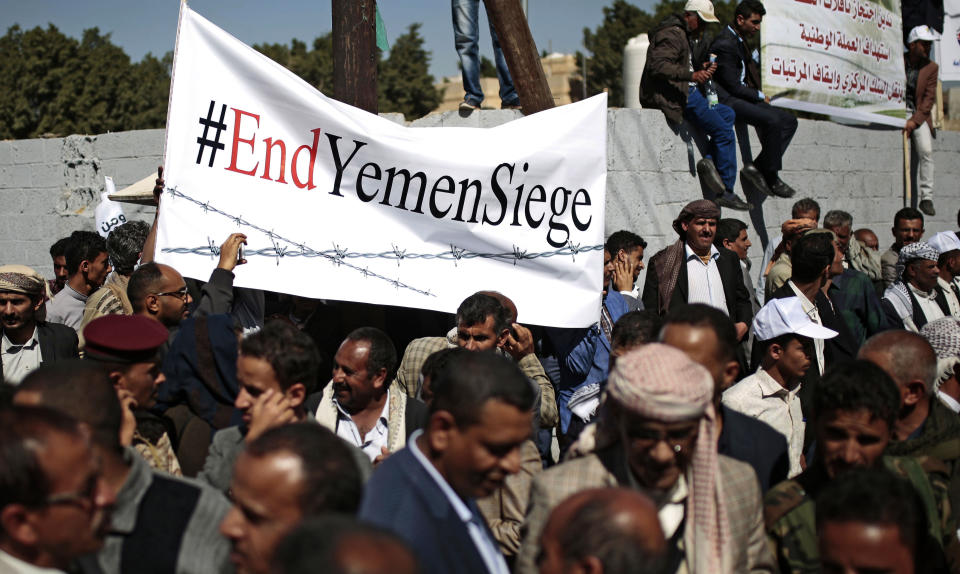FILE - In this Dec. 10, 2018 file photo, Yemenis take part in a protest calling for the reopening of Sanaa airport to receive medical aid, in front of the U.N. offices in Sanaa, Yemen. An Associated Press investigation found some of the United Nations aid workers sent in to Yemen amid a humanitarian crisis caused by five years of civil war have been accused of enriching themselves from an outpouring of donated food, medicine and money. Documents from an internal probe of the U.N.’s World Health Organization uncovered allegations of large funds deposited in staffers’ personal bank accounts, suspicious contracts, and tons of donated medicine diverted or unaccounted for. (AP Photo/Hani Mohammed, File)