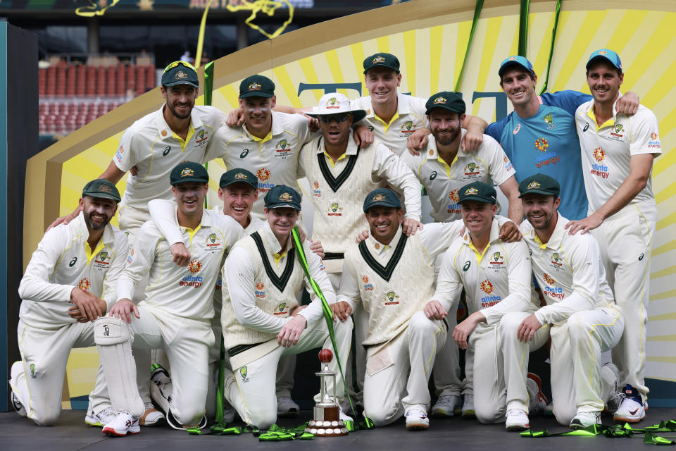 The Australian team pose with their trophy after their 2-0 cricket test series win over the West Indies in Adelaide, Sunday, Nov. 11, 2022. (AP Photo/James Elsby)