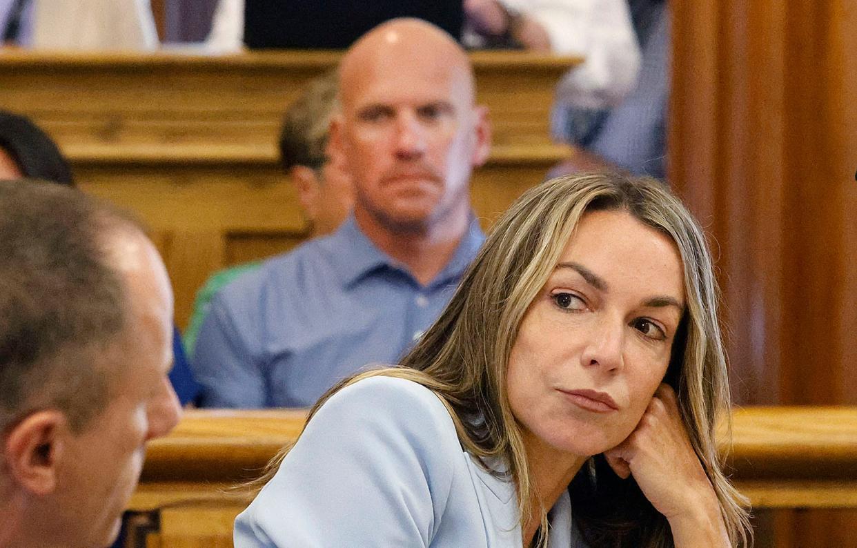 Karen Read listens to arguments over whether the judge should drop some of the charges against her during a hearing in Norfolk Superior Court in Dedham on Friday, Aug. 9, 2024. A mistrial was declared in July, when she stood trial for the second-degree murder of her boyfriend John O'Keefe and related charges.