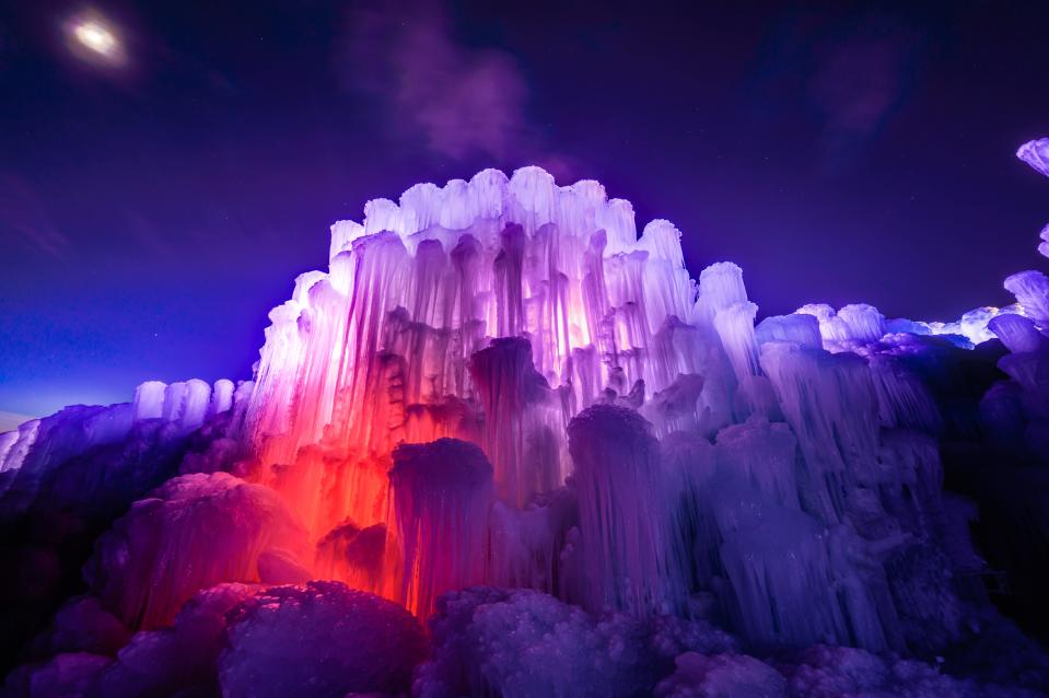 At night, Ice Castles light up in an array of colors provided by illumination from within the structure.