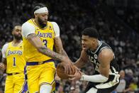Los Angeles Lakers' Anthony Davis strips the ball from Milwaukee Bucks' Giannis Antetokounmpo during the second half of an NBA basketball game Tuesday, March 26, 2024, in Milwaukee. The Lakers won 128-124 in double overtime. (AP Photo/Morry Gash)