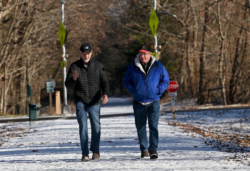 Herb Brockert, left, and Robert Weidknecht, both of the Holliston Trails Committee, walk the Holliston Rail Trail, Dec. 9, 2021. The path is part of the Upper Charles Rail Trail.
