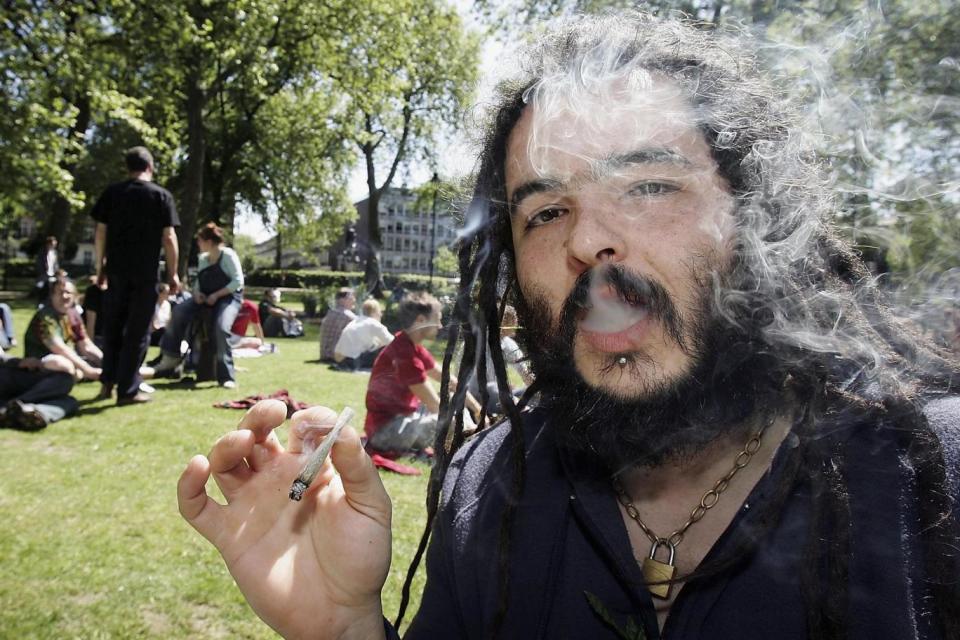 A man smokes a joint as people gathered in Russell Square for the start of a cannabis march in London (Getty Images)