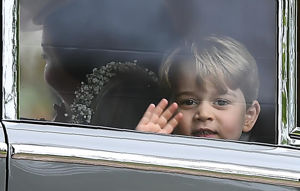 Prince George waves as he leaves the church with his sister and mother, heading to the post-ceremony drinks reception