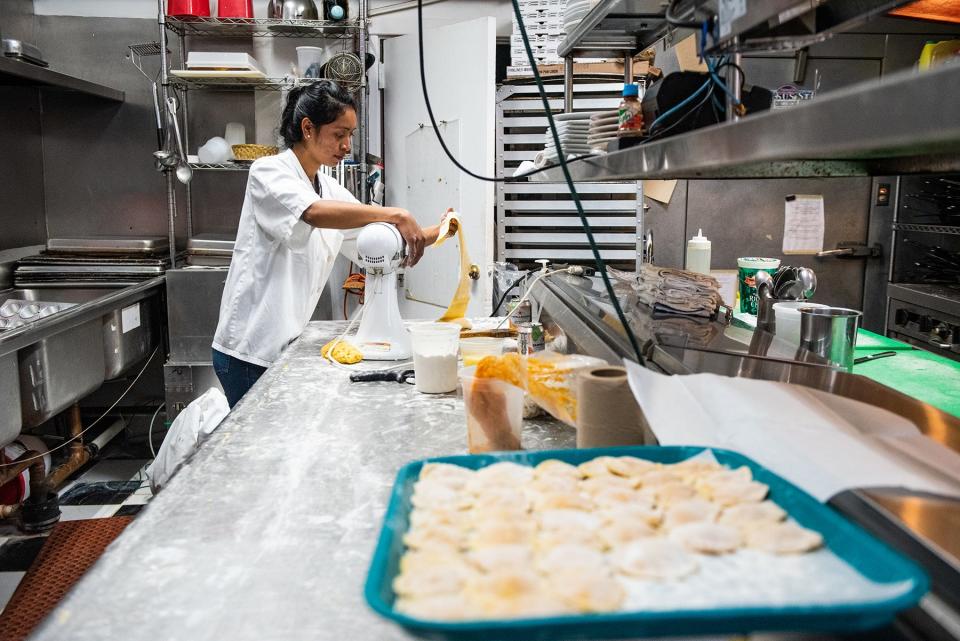 Cook Mirian Tecún rolls out pasta dough in the kitchen at Wildfire Grill in Montgomery on November 17.