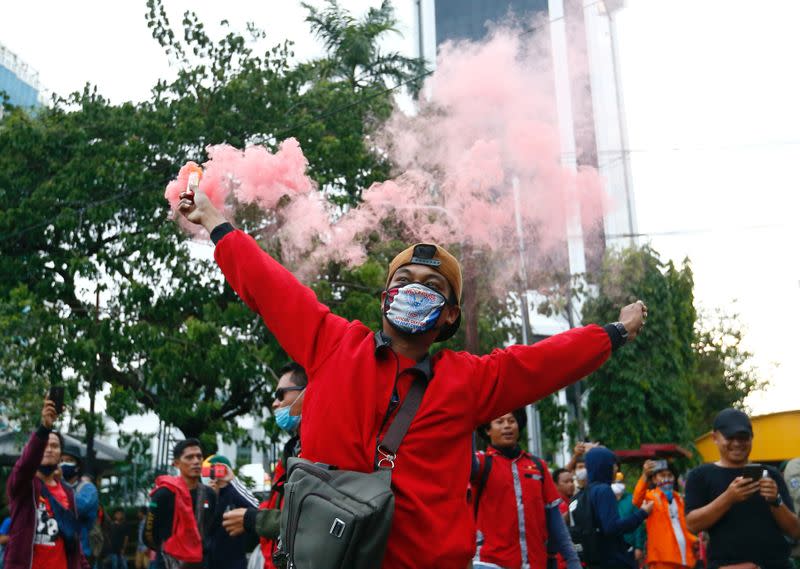 FILE PHOTO: Trade union members protest against government's labor reforms in Jakarta