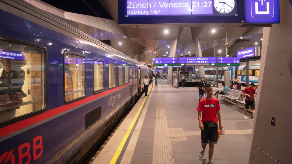 Passengers are seen on the platform in front of the Nightjet train line Vienna-Venice (-Zurich) of the Austrian Federal Railways. Night trains are making a comeback in Europe, thanks to their low-carbon footprint. - Alex Halada/AFP/Getty Images