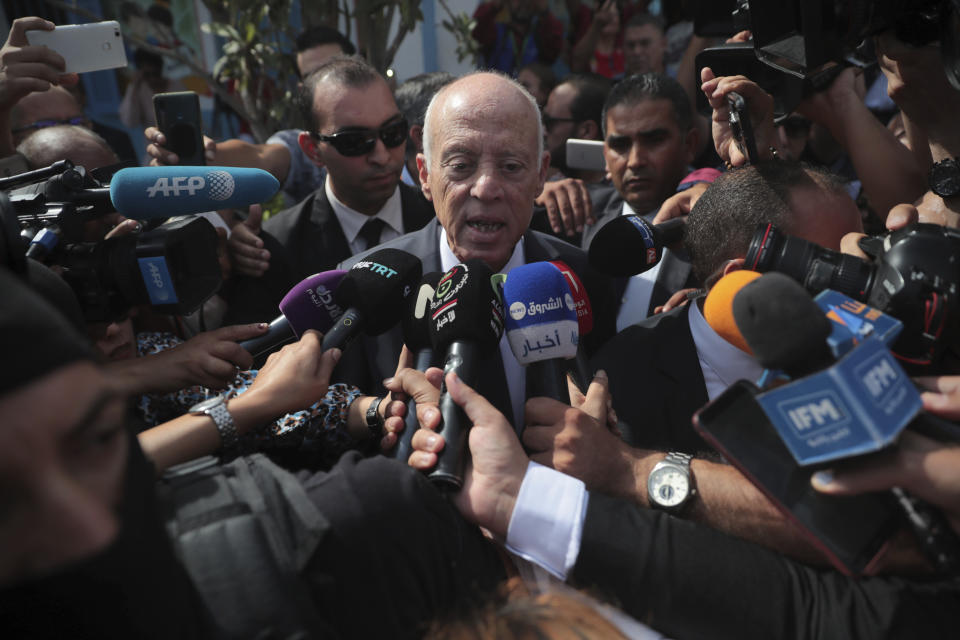 Tunisian independent law professor and presidential candidate Kais Saied speaks to journalists after casting his ballot in a polling station during the second round of the presidential election, in Tunis, Tunisia, Sunday, Oct. 13, 2019. Tunisians are voting for president, choosing between a law professor and populist tycoon. (AP Photo/Mosa'ab Elshamy)