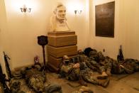 <p>National Guard troops sleep on the floor of the Capitol Visitor Center on Wednesday, Jan. 13, 2021, as security ramps up in advance of the Inauguration.</p>