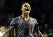 In this Dec. 28, 2013 file photo, UMass guard Derrick Gordon celebrates after hitting the go-ahead basket with one second left on the clock during overtime of an NCAA college basketball game against Providence, in Amherst, Mass. Gordon says in a televised interview that he is gay. Gordon made the announcement on ESPN on Wednesday, April 9, 2014, becoming the first openly gay player in Division I men's basketball. (AP Photo/Jessica Hill, File)