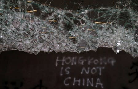 Broken glass and graffiti are seen at the Legislative Council, a day after protesters broke into the building in Hong Kong