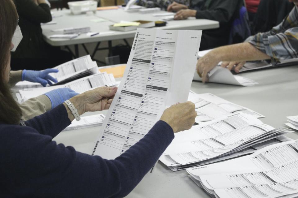 An election worker examines a ballot at the Clackamas County Elections office on May 19, 2022, in Oregon City, Ore. <a href="https://newsroom.ap.org/detail/ElectionOfficialsThreats/1d3638312378468f9930cfd62587f86a/photo?Query=election%20worker&mediaType=photo&sortBy=arrivaldatetime:desc&dateRange=Anytime&totalCount=10505&currentItemNo=18" rel="nofollow noopener" target="_blank" data-ylk="slk:AP Photo/Gillian Flaccus;elm:context_link;itc:0;sec:content-canvas" class="link ">AP Photo/Gillian Flaccus</a>