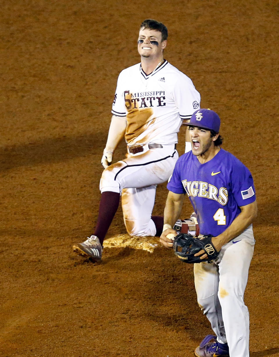 LSU shortstop Josh Smith (4) reacts after tagging Mississippi State's Tanner Allen (5) out at second base during the 15th inning of the Southeastern Conference tournament NCAA college baseball game, early morning Thursday, May 23, 2019, in Hoover, Ala. (AP Photo/Butch Dill)