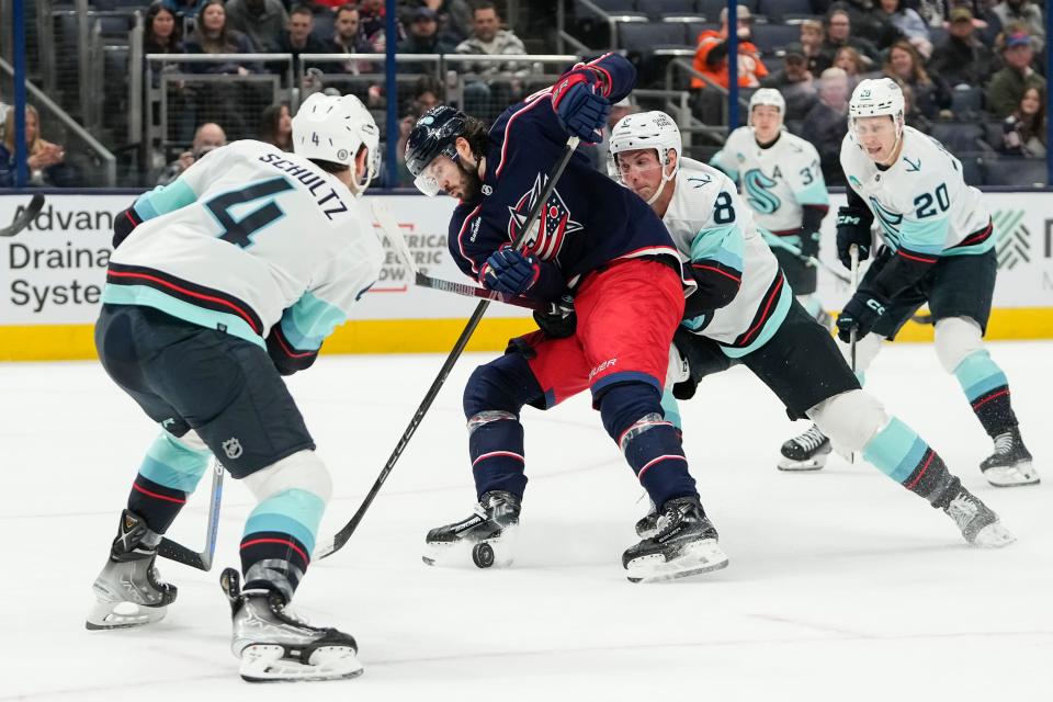 Jan 13, 2024; Columbus, Ohio, USA; Columbus Blue Jackets right wing Kirill Marchenko (86) skates up ice past Seattle Kraken defenseman Brian Dumoulin (8) during the first period of the NHL hockey game at Nationwide Arena.