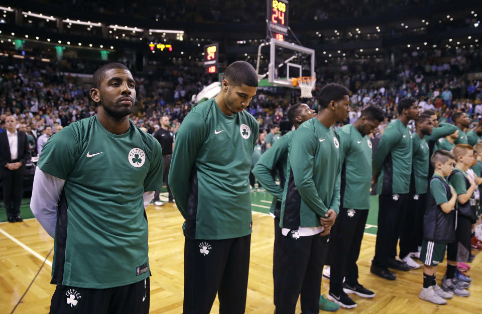 <p>Boston Celtics guard Kyrie Irving, left, and his teammates pause for a moment of silence for victims of the Las Vegas concert shooting, prior to the team’s NBA preseason basketball game against the Charlotte Hornets in Boston, Monday, Oct. 2, 2017. (Photo: Charles Krupa/AP) </p>