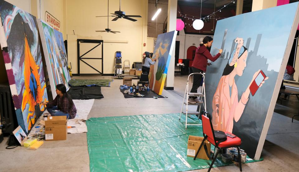 From left, Savannah Tallbear, Nayelly Morales Rojo and Janely Saavedra Cruz work on their murals for this year's Fresh Paint: OKC NYE Mural Project at the OKC Farmers Public Market Monday, November 7, 2022.