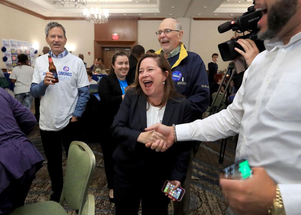 Shelly Simonds celebrates with supporters Tuesday at the Marriott in Newport News, Va., as election results begin to come in for her race for the House of Delegates.