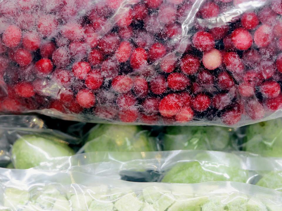 Organic frozen whole cranberries and kiwi in vacuum bag