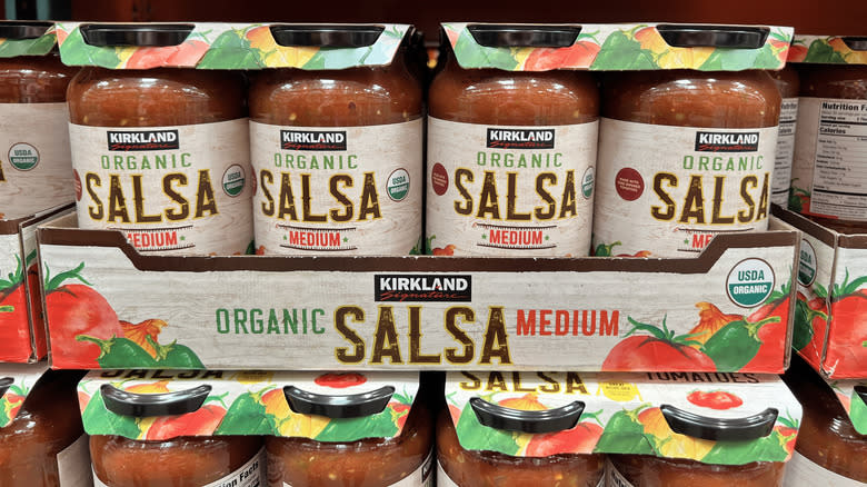 Two packs of Kirkland Signature Organic Salsa stacked in Costco aisle
