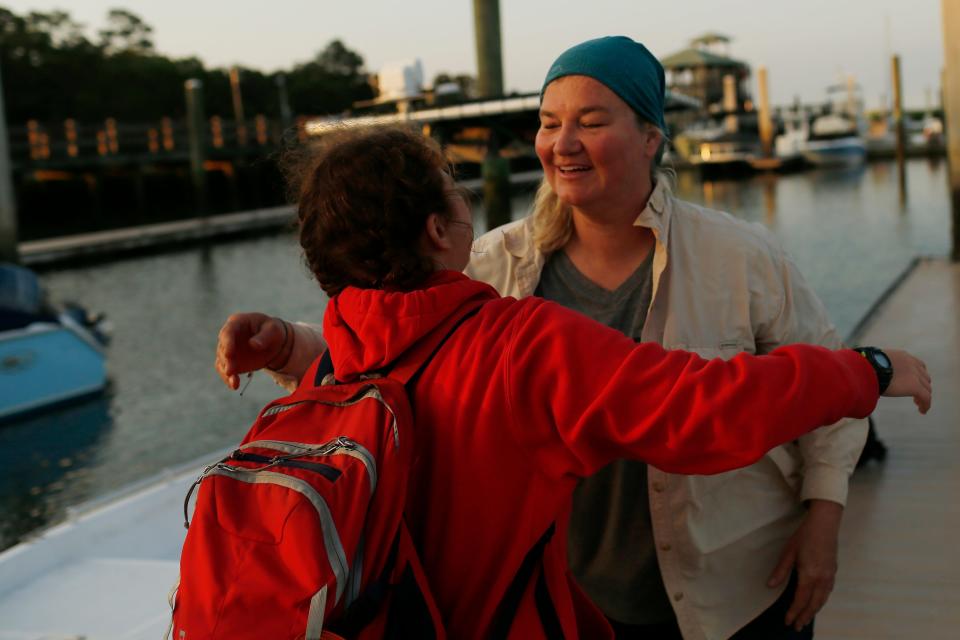 Kris Williams, director of the Caretta Research Project, hugs a volunteer after arriving at the marina to drop off volunteers from Wassaw Island in Savannah, Ga., on Thursday, June 2, 2022.