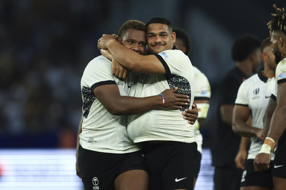 Fiji's Ilaisa Droasese, left, and Fiji's Samuel Matavesi celebrate after the Rugby World Cup Pool C match between Australia and Fiji at the Stade Geoffroy Guichard in Saint-Etienne, France, Sunday, Sept. 17, 2023. (AP Photo/Aurelien Morissard)