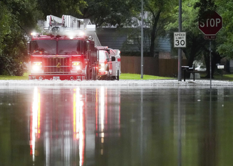 A Houston firetruck makes it way through flood water in North Woodland Hills after severe flooding, Thursday, May 2, 2024, in the Houston neighborhood of Kingwood, Texas. (Jason Fochtman/Houston Chronicle via AP)