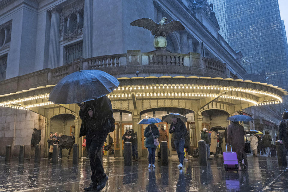 People with umbrellas during heavy rain in New York on April 3, 2024.  (Angela Weiss / AFP - Getty Images)