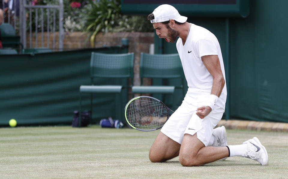 Karen Khachanov (pictured) falls down as he celebrates his win over Sebastian Korda at Wimbledon.