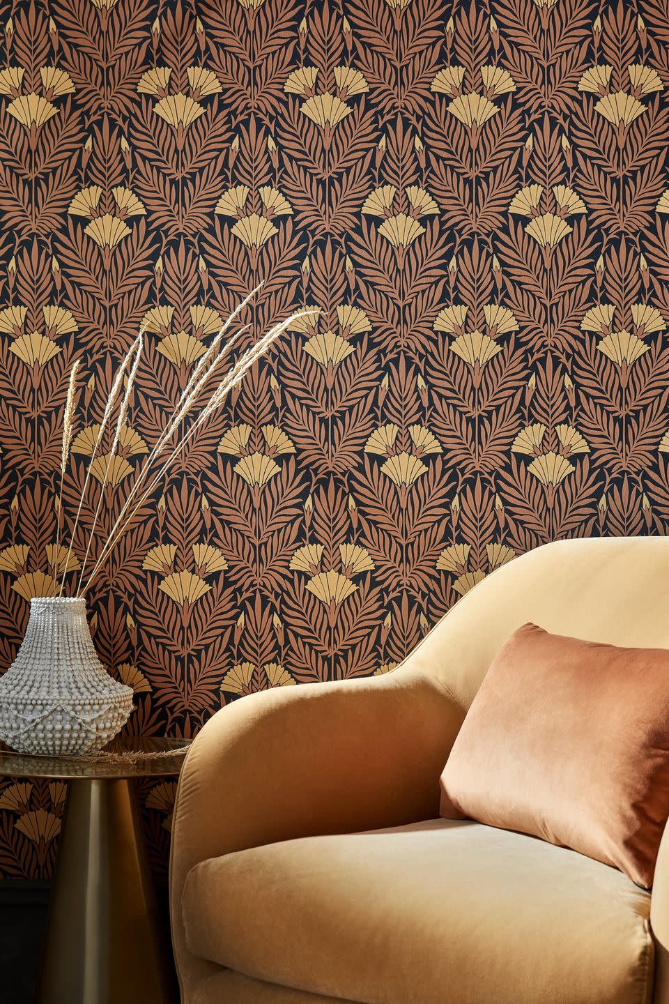 brown patterned wallpaper and golden yellow velvet armchair