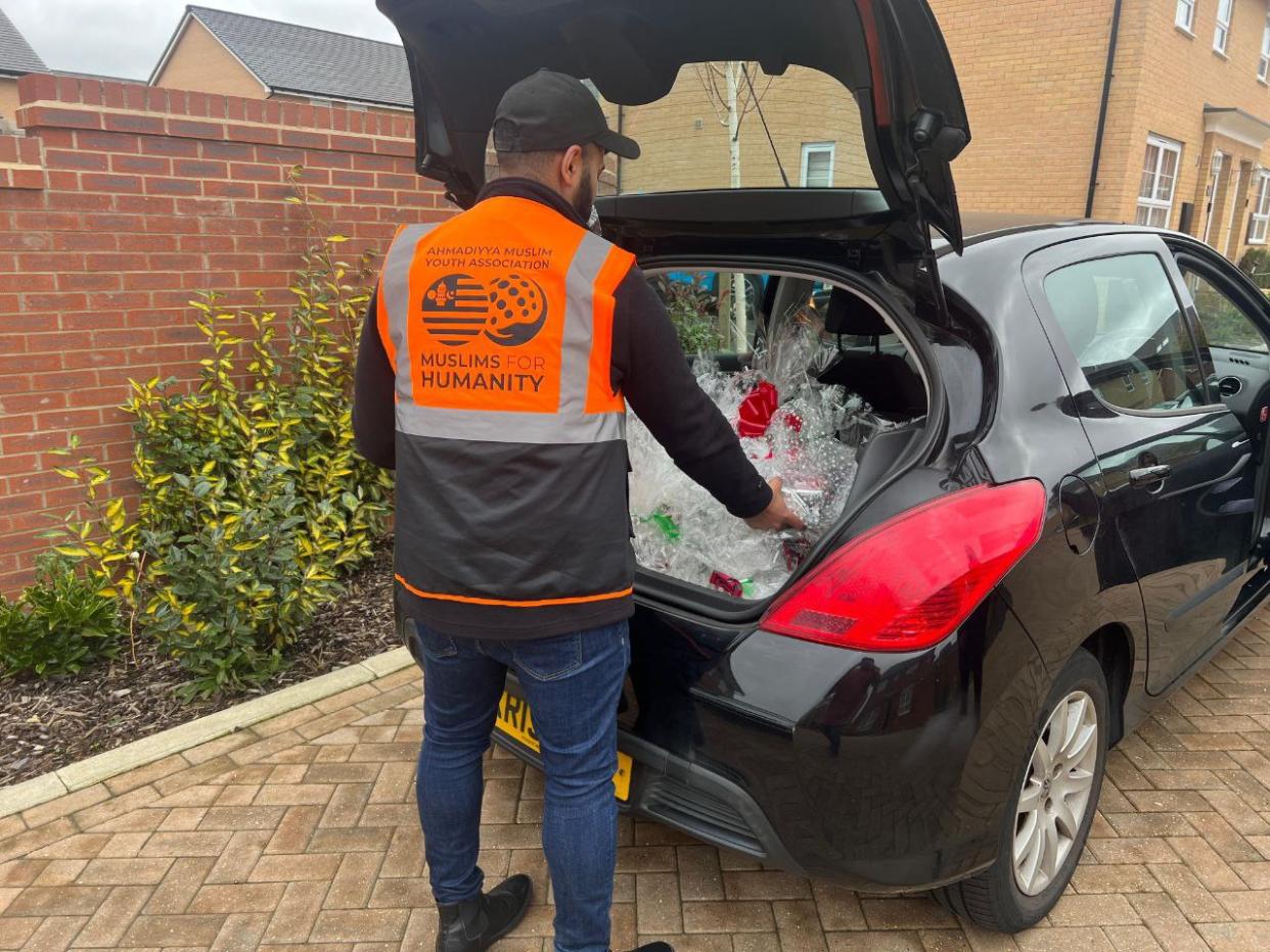 Man putting something into the trunk of his car