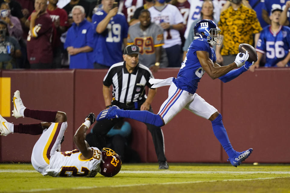 New York Giants wide receiver Darius Slayton (86) makes a touchdown catch against Washington Football Team cornerback William Jackson (23) during the second half of an NFL football game, Thursday, Sept. 16, 2021, in Landover, Md. (AP Photo/Patrick Semansky)