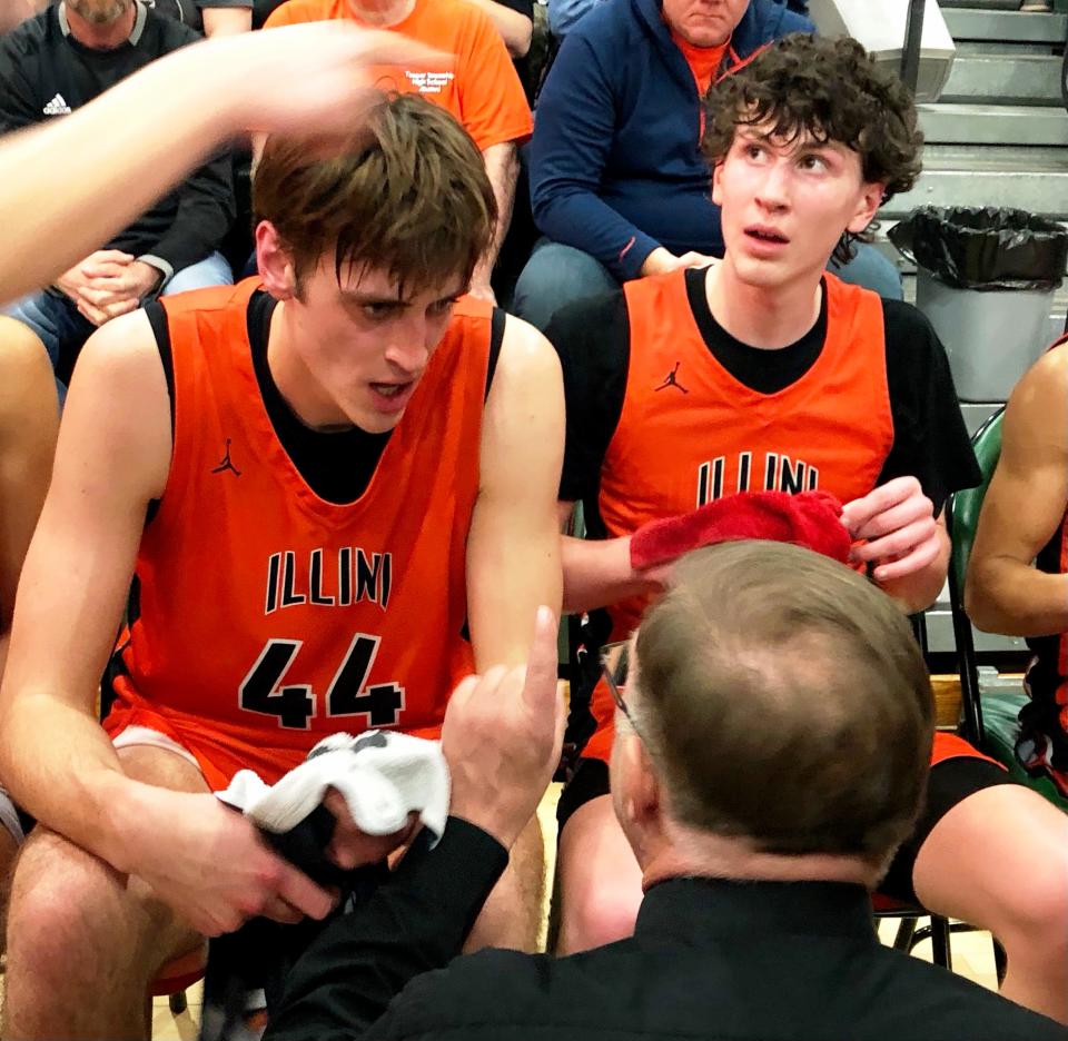 Senior center Hank Alvey listens intently to Illini Bluffs head coach Clay Vass during a 47-35 victory over Camp Point Central in the IHSA Class 1A boys Abingdon Sectional championship game on Friday, March 1, 2024.