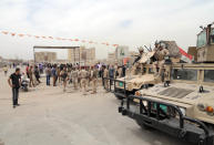 Iraqi security forces stand guard at the main gate of a Shiite private college following an attack by militants, in Baghdad’s eastern neighborhood of Ur, Iraq, Sunday, April 20, 2014. A suicide bomber with an explosives belt attacked the main gate of a Shiite private college while three militants attacked the back gate, leaving several people dead and over a dozen people were wounded. Security forces killed all of the attackers. (AP Photo/Khalid Mohammed)