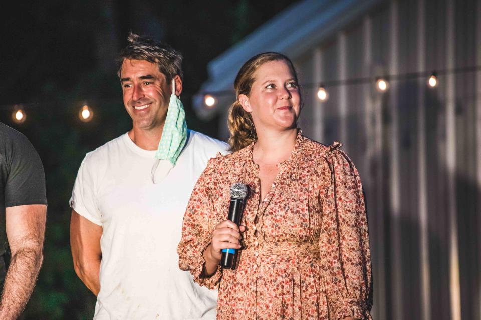 Comedian/actress Amy Schumer, right, with husband Chris Fischer, a Martha's Vineyard chef, introduce the documentary about her pregnancy in 2020 at the Oak Bluffs drive-in set up by the Martha's Vineyard Film Festival.