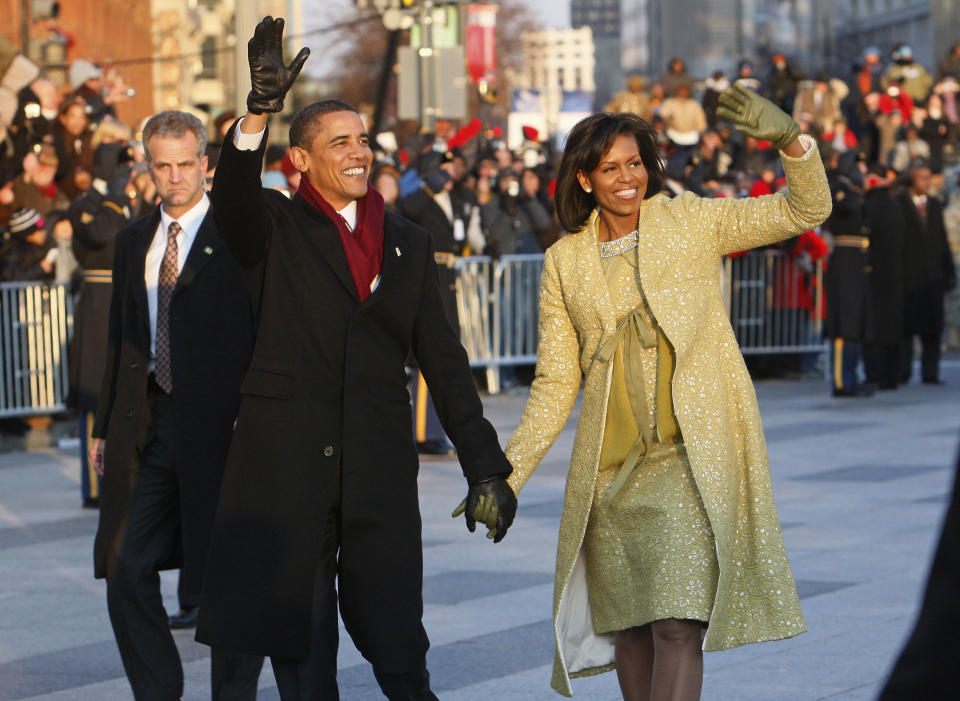 FILE - In this Jan. 20, 2009, file photo, President Barack Obama and first lady Michelle Obama walk the inaugural parade route in Washington. Obama's second inauguration is shaping up as a high-energy celebration smaller than his first milestone swearing-in, yet still designed to mark his unprecedented role in American history with plenty of eye-catching glamour. A long list of celebrity performers will give the once-every-four years right of democratic passage the air of a star-studded concert, from the bunting-draped Capitol's west front of the Capitol, where Obama takes the oath Jan. 21, to the Washington Convention Center, which is expected to be packed with 40,000 ball-goers that evening. (AP Photo/Charles Dharapak)