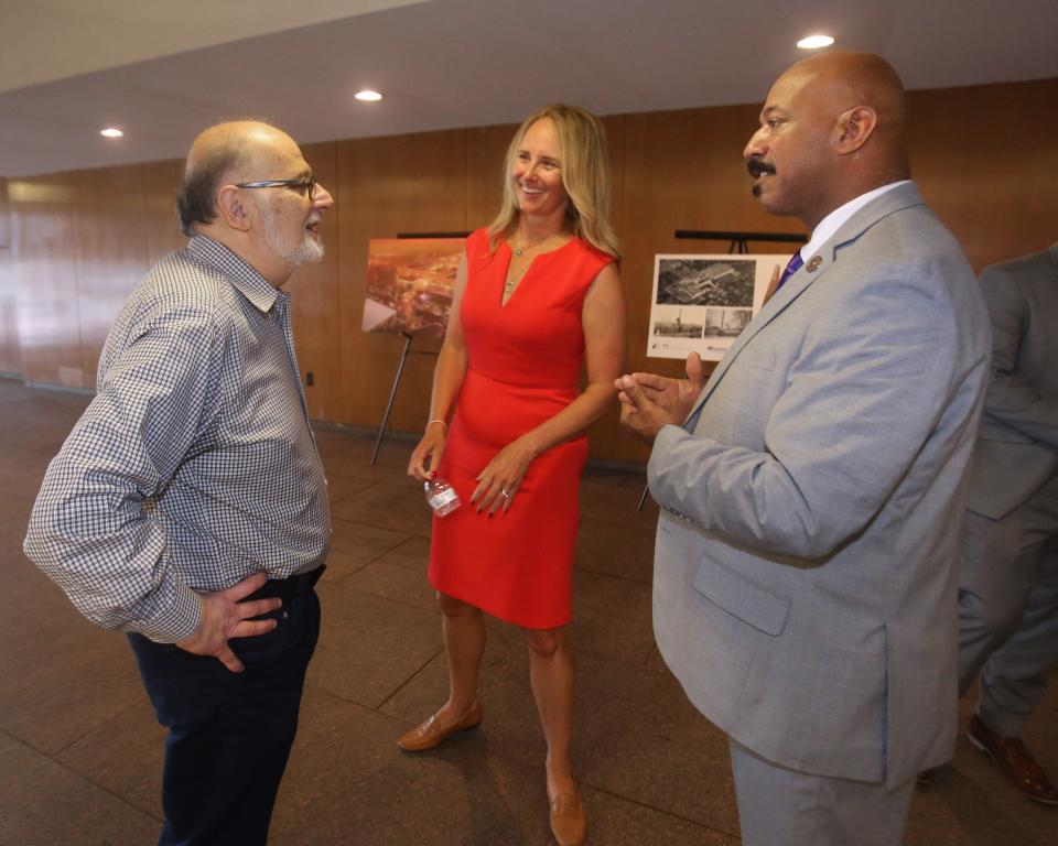 Stuart Lichter, president and founder of Industrial Realty Group, speaks with Lydia L. Mihalik, center, director of the Ohio Department of Development, and Rep. Thomas West, D-Canton, after a tour of the Hoover District in North Canton.