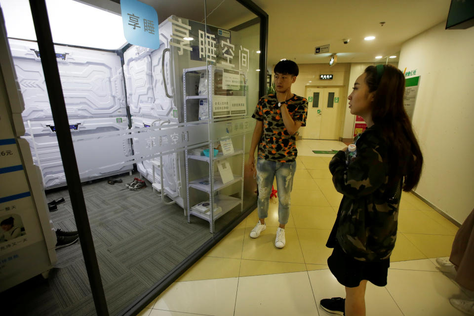 A woman waits to enter a capsule bed unit at Xiangshui Space during lunch break in Beijing's Zhongguancun area, China July 11, 2017. REUTERS/Jason Lee