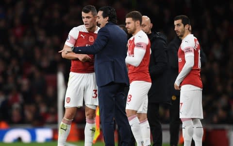 Arsenal Head Coach Unai Emery talks to midfielder Granit Xhaka during the Premier League match between Arsenal FC and Wolverhampton Wanderers - Credit: ARSENAL FC