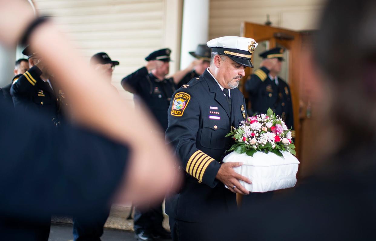 Plain City Police Chief Dale McKee carries out the tiny casket of "Madison Baby Doe" or as the community refers to her, "Baby Madison", during a procession and burial on June 24. The unidentified infant was found in the trash, on June 15th. The baby still hasn't been identified but police say the case remains a priority.