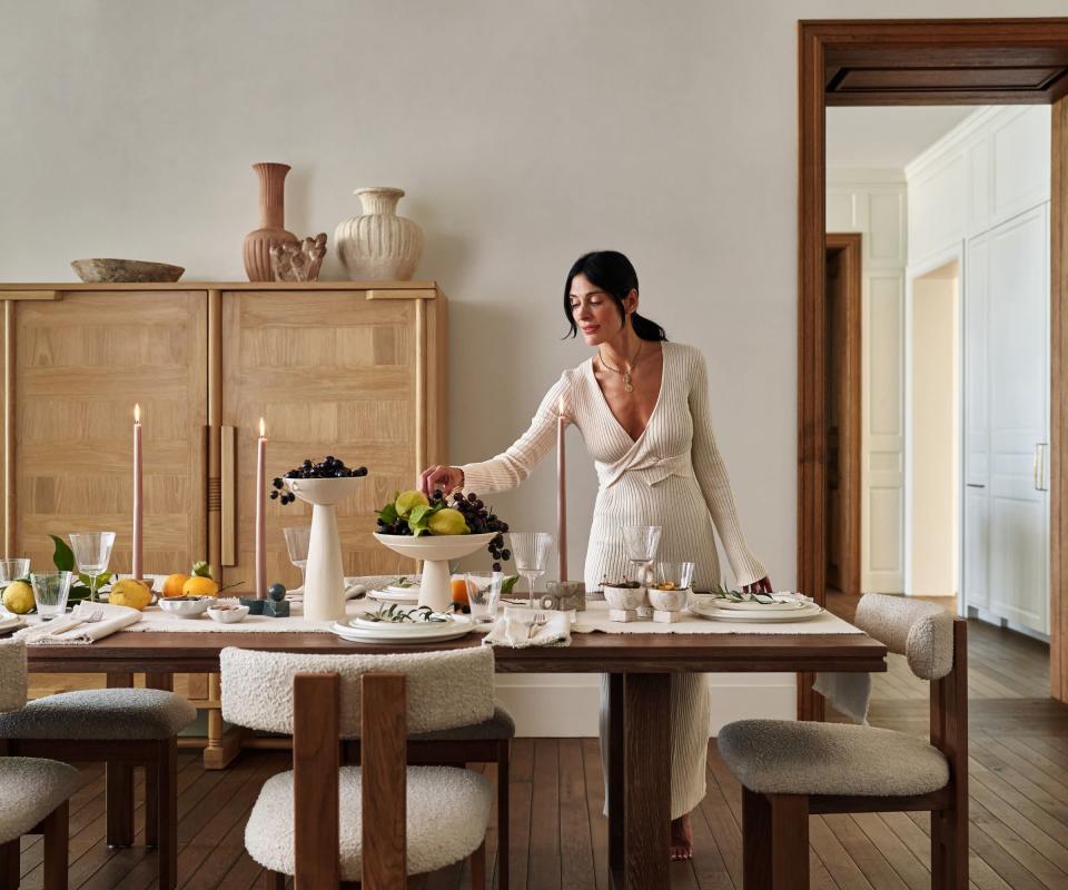 Dining room with Athena Calderone lighting a candle