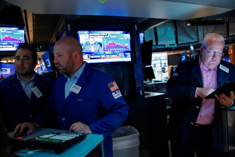 Traders work on the floor of the NYSE in New York