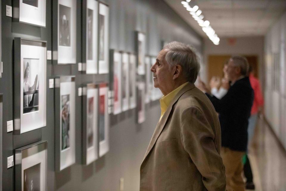 Bill Robbins looks at images that are part of the CARASMATIC: THROUGH THE LENS OF A DANCER photography exhibit at the Kravis Center featuring images from the personal archive of photographer Steven Caras, Thursday December 8, 2022.