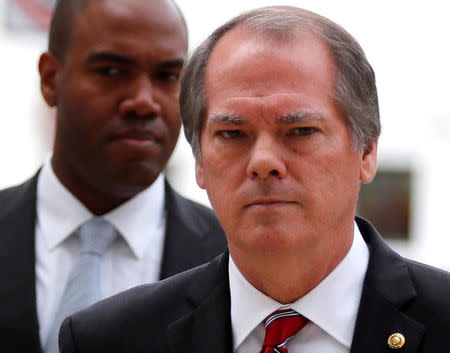 FILE PHOTO: James Wolfe, a longtime staffer of the Senate Intelligence Committee escorts Michael Cohen (not shown), personal attorney for U.S. President Donald Trump, as he arrives to appear before Senate Intelligence Committee staff as the panel investigates alleged Russian interference in the 2016 U.S. presidential election, on Capitol Hill in Washington, U.S. September 19, 2017. REUTERS/Jonathan Ernst/File Photo