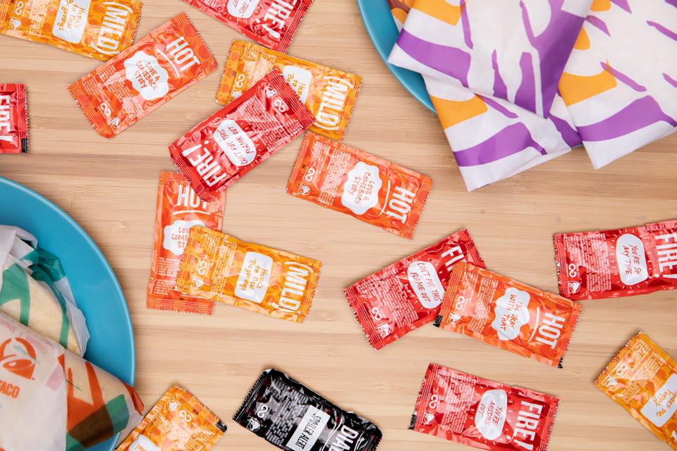 Taco Bell sauces on a table with Taco Bel foods