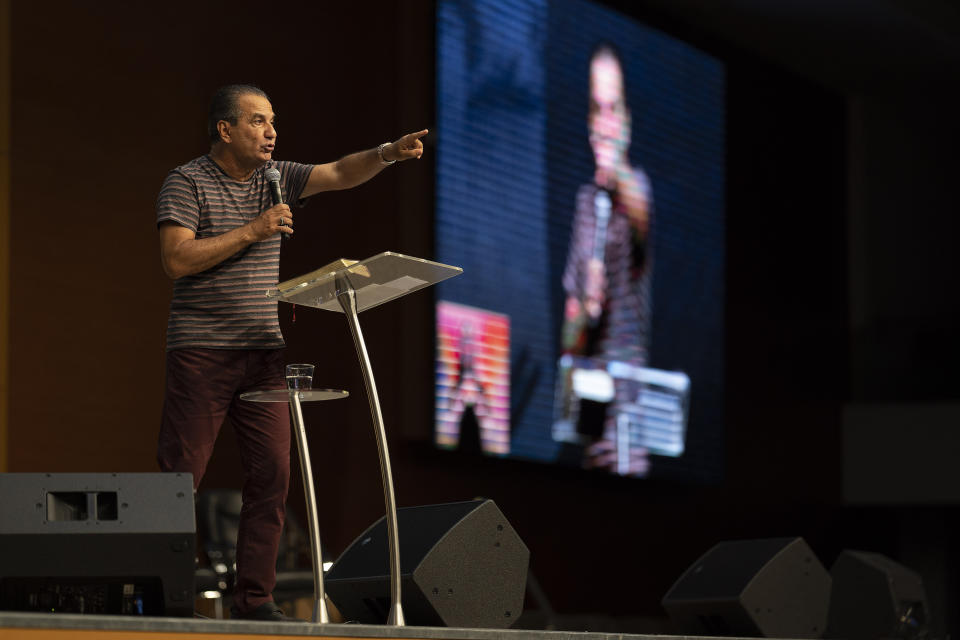 Pastor Silas Malafaia delivers a sermon during a service transmitted on live through social networks, at the empty Assembly of God Victory in Christ Church in reason to the restrictions for agglomerations due the new coronavirus, in Rio de Janeiro, Brazil, Sunday, March 29, 2020. Brazil's President Jair Bolsonaro, a conservative Catholic who married an evangelical in a service Malafaia administered, has zeroed in on the need to reopen the churches. “God is Brazilian,” he told people on Sunday, local paper O Globo reported. (AP Photo/Leo Correa)