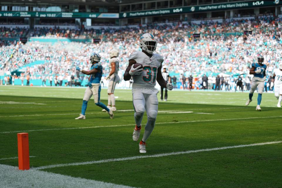 Miami Dolphins running back Raheem Mostert (31) scores a touchdown against the Carolina Panthers during the first half of an NFL game at Hard Rock Stadium in Miami Gardens, Oct. 15, 2023.