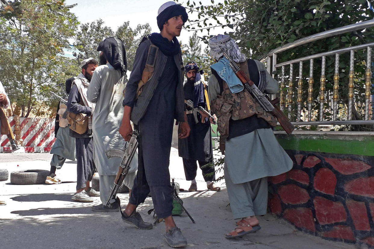 Taliban fighters stand along the roadside in Ghazni, Afghanistan, on Aug. 12, 2021. (AFP - Getty Images)