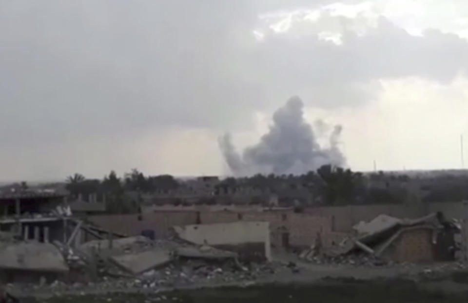 This frame grab from video provided on Tuesday, Feb. 12, 2019, by the Syrian Observatory for Human Rights, an opposition group, that is consistent with independent AP reporting, shows smoke rising from a shell that targeted Islamic State group militants, in the village of Baghouz, Deir El-Zour, eastern Syria. Fighting between U.S.-backed fighters and IS inflicted more casualties among people fleeing the violence in eastern Syria Tuesday where the extremists are on the verge of losing the last area they control. (Syrian Observatory for Human Rights via AP)